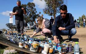 People light candles in memory of youths taken captive or killed by Hamas militants during the attack on revellers attending the Supernova music festival on October 7, 2023, at the site where the event took place near Kibbutz Reim in southern Israel, on February 7, 2024, as the war between Israel and the militant Hamas group in Gaza continues. (Photo by JACK GUEZ / AFP)