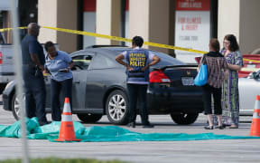 Investigators at a Houston mall where a guman wounded nine people before being fatally shot by police.