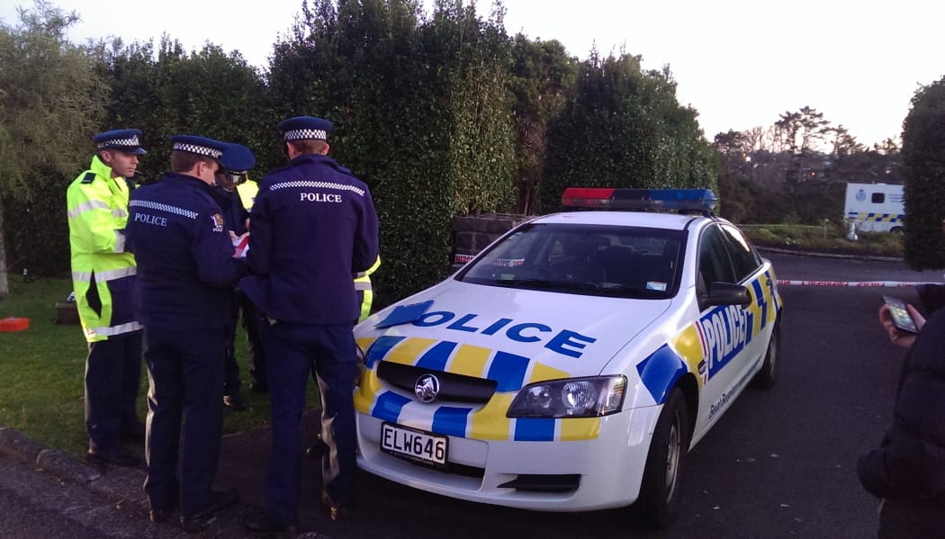 Officers at the entrance to Birkenhead Glenfield cemetery on Tuesday.