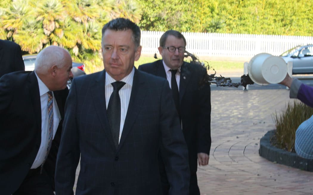 John Banks being hit by a bucket of mud at the start of his trial.