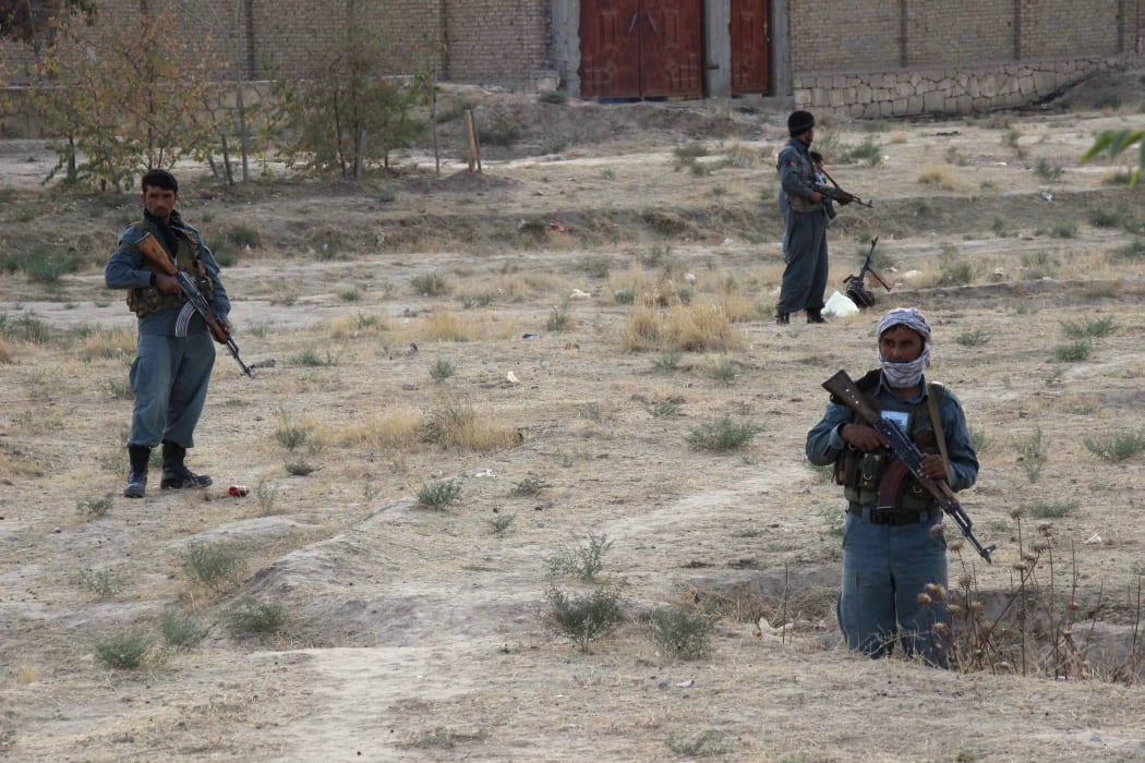 Afghan security personnel keeping watch as heavy fighting erupts near the airport on the outskirts of Kunduz.