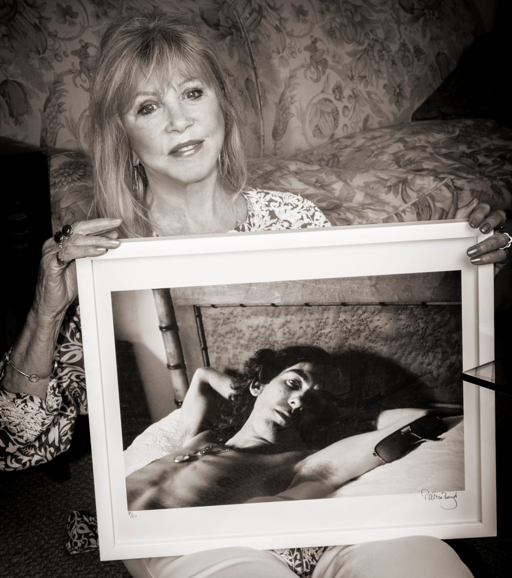 Pattie Boyd with a photo she took of George Harrison