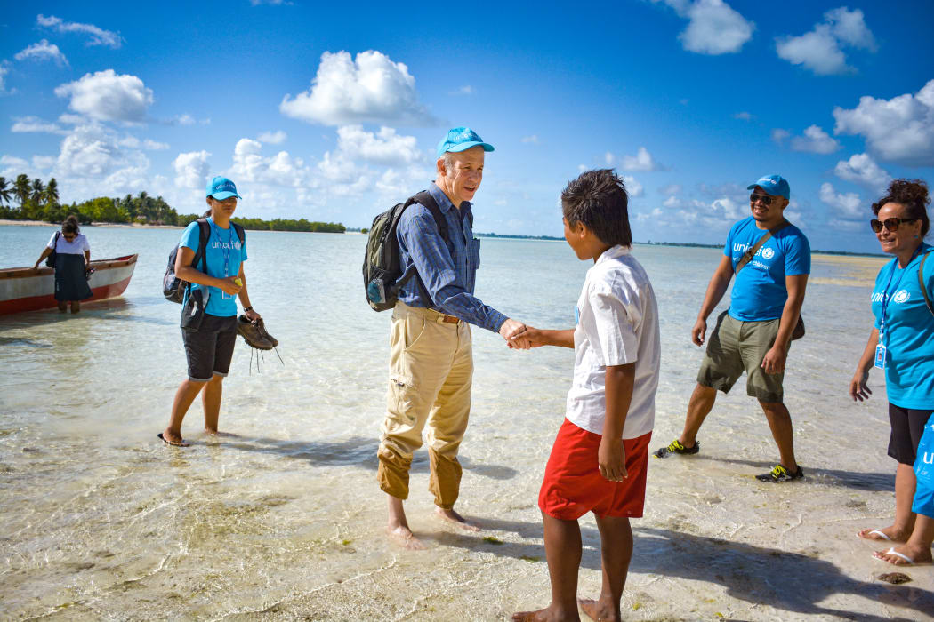 The UNICEF's rep in the Pacific, Sheldon Yett, meets school children on his arrival in north Tarawa, Kiribati.