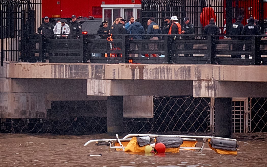 NEW JERSEY, JERSEY CITY - APRIL 10: Police and firefighters work on the site after a helicopter crashed in the Hudson River on April 10, 2025 in Jersey City, New Jersey. All six people on board were killed when a helicopter plunged into the Hudson River off of Lower Manhattan.   Andres Kudacki/Getty Images/AFP (Photo by ANDRES KUDACKI / GETTY IMAGES NORTH AMERICA / Getty Images via AFP)