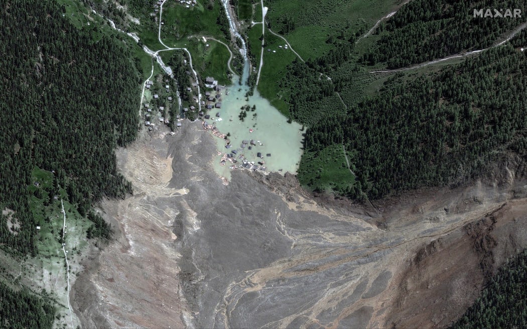 This handout satellite image courtesy of Maxar Technologies created on May 29, 2025, shows the small village of Blatten and its surroundings in the Bietschhorn mountain of the Swiss Alps, Switzerland on May 29, 2025 after it was destroyed the previous day by a landslide after part of the huge Birch Glacier collapsed and swallowed up by the river Lonza.
(COMBO). Swiss authorities were on May 29, 2025 monitoring for possible flood risk in a southern valley, following a massive glacier collapse that created a huge pile of debris after destroying a small village. On May 28 the Birch glacier in Switzerland's southern Wallis region collapsed, sending tons of rock, ice and scree hurtling down the mountain slope and into the valley below. The barrage largely destroyed the hamlet of Blatten, which had been home to 300 people and was evacuated last week due to the impending danger. (Photo by Handout / Satellite image ©2025 Maxar Technologies / AFP) / RESTRICTED TO EDITORIAL USE - MANDATORY CREDIT "AFP PHOTO/...