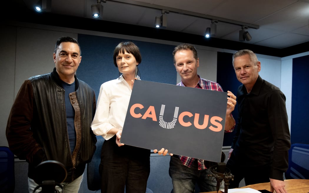 Julian Wilcox, Lisa Owen, Tim Watkin and Guyon Espiner. Lisa and Tim hold a sign for their election podcast Caucus.