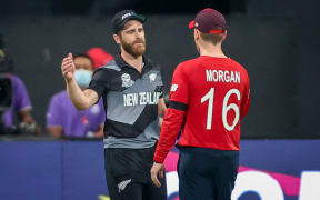 Captain Kane Williamson (L) of the New Zealand BlackCaps shakes hands with captain Eoin Morgan of England after the ICC Men's T20 World Cup semifinal
