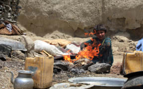 An Afghan child is seen outside of a damaged house after the magnitude 6.1 quake shakes border provinces of Paktika, Afghanistan.