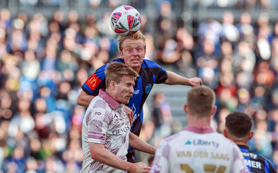 Auckland FC's Francis de Vries up against Brisbane Roar FC's Ben Halloran.
