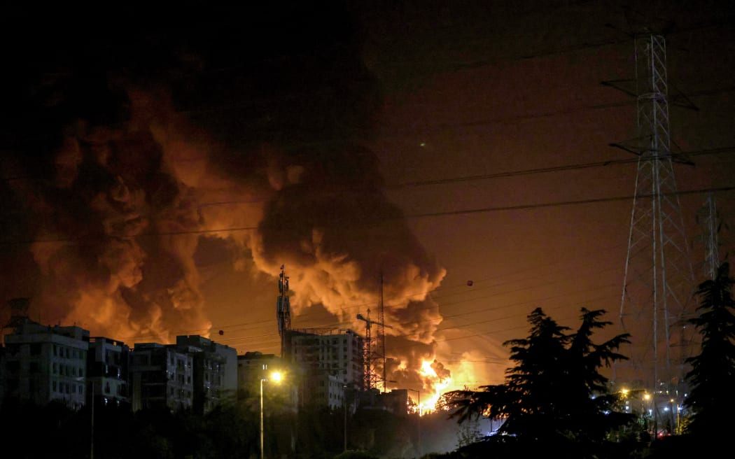 A fire blazes in the oil depots of Shahran, northwest of Tehran, on June 15, 2025. Israel and Iran exchanged fire on June 14, a day after Israel unleashed an unprecedented aerial bombing campaign that Iran said hit its nuclear facilities, "martyred" top commanders and killed dozens of civilians. (Photo by ATTA KENARE / AFP)