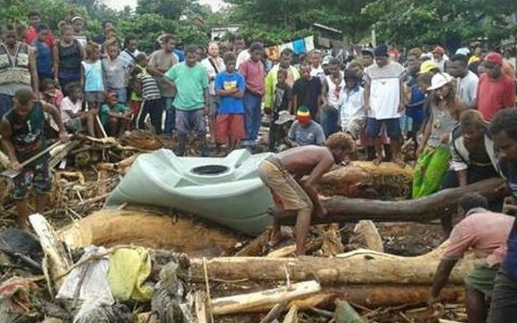 Searchers looking for survivors or bodies in debris left by the flood.