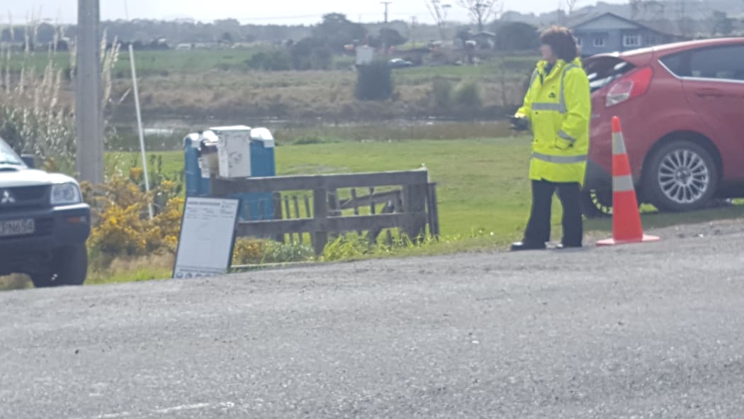 Security staff at the entrance to a property near the pipeline break on Ruakaka Road.
