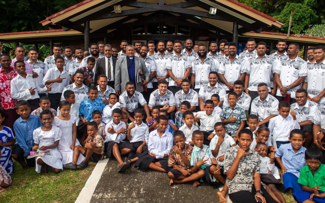 The Flying Fijians with villagers of Somosomo village in Taveuni after their Sunday service on 2 July 2023.