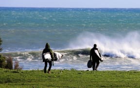 Surfers make their way to Puniho Road surfbreak.