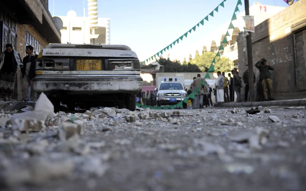 Yemenis gather at the scene of a bomb in Sanaa on 5 January 2015.