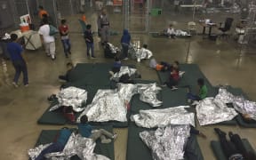 Border crossers held by US Border Patrol agents at the Central Processing Center in McAllen, Texas.