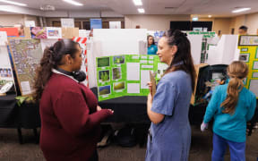 A student from Rotorua Girls' High School explains her project at Te Tūkohu Ngāwhā Mātauranga Māori Science and Design Fair in 2024.