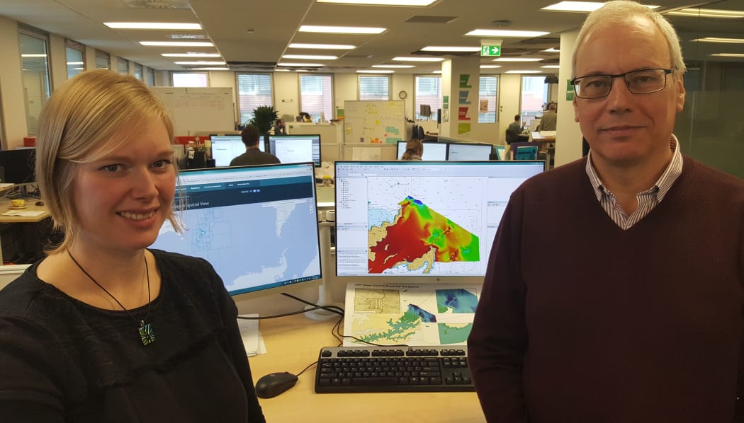 Hydrographers Annette Wilkinson and Adam Greenland. The coloured image on the computer screen is an electronic chart of the sea floor.