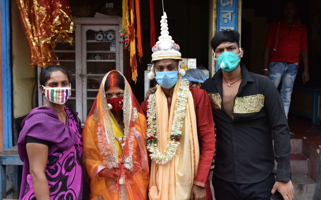 Relatives with the newly wedded couple posed for a photograph during a visit to the Holy Shrine Of Kali Temple in Kolkata, India, on July 24, 2020.