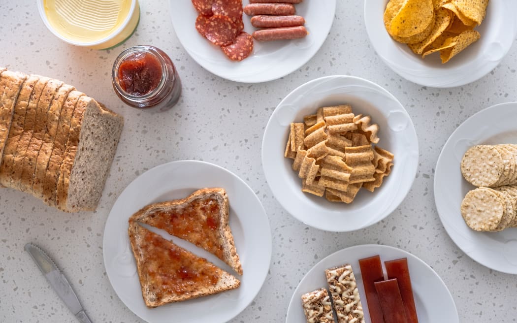 A collection of snack foods on a kitchen bench