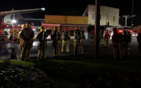 Smoke and a red glow was seen rising over Onehunga after a commercial building caught fire on 26 May, 2024.