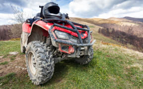 ATV on mountains landscape on a sunny day