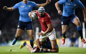 France's centre Alexandre Dumoulin (C) is tackled during a Pool D match of the 2015 Rugby World Cup between France and Italy at Twickenham stadium.