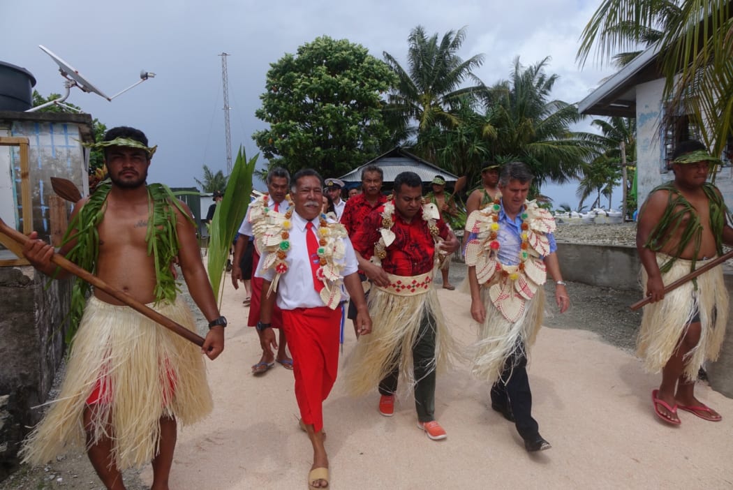 NZ Govt Minister Kris Faafoi welcomed onto Fakaofa in Tokelau. He is accompanied by NZ Administrator Ross Ardern and the Ulu O Tokelau Afega Gaualofa