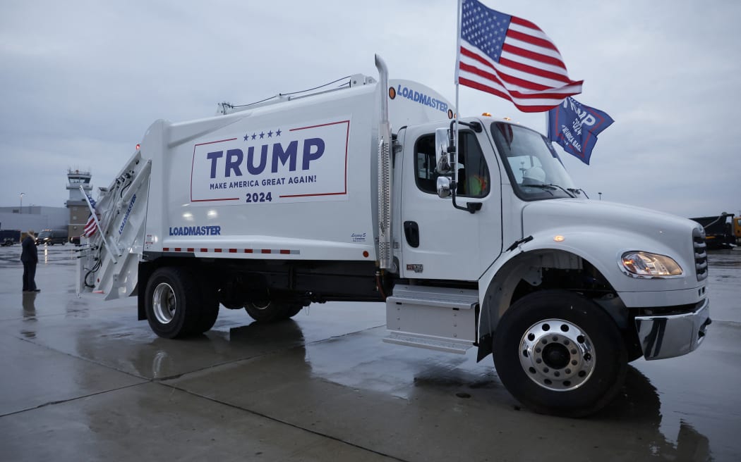 GREEN BAY, WISCONSIN - OCTOBER 30: A garbage truck is is decked out with campaign signs and flags for Republican presidential nominee, former President Donald Trump on the tarmac at Green Bay Austin Straubel International Airport on October 30, 2024 in Green Bay, Wisconsin. With less than a week until Election Day, Trump continues to campaign in the battleground swing states.   Chip Somodevilla/Getty Images/AFP (Photo by CHIP SOMODEVILLA / GETTY IMAGES NORTH AMERICA / Getty Images via AFP)