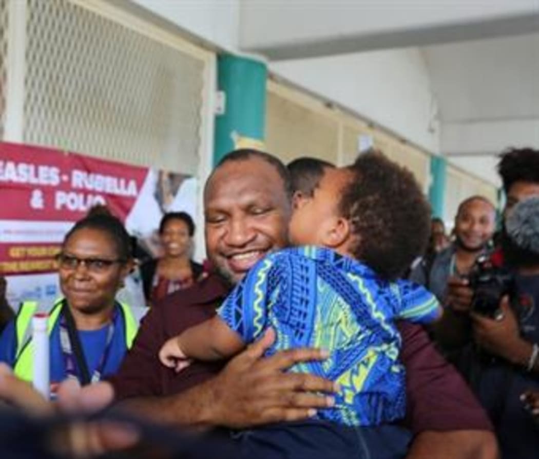 James Marape with two-year-old Herman Luk