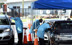 People are tested for COVID-19 at a drive through testing site sponsored by the city at Camping World Stadium on July 8, 2020 in Orlando, Florida.