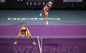 Erin Routliffe of New Zealand serves and Canadian doubles partner Gabriela Dabrowski of Canada is ready at the net during the WTA Finals in Cancun.