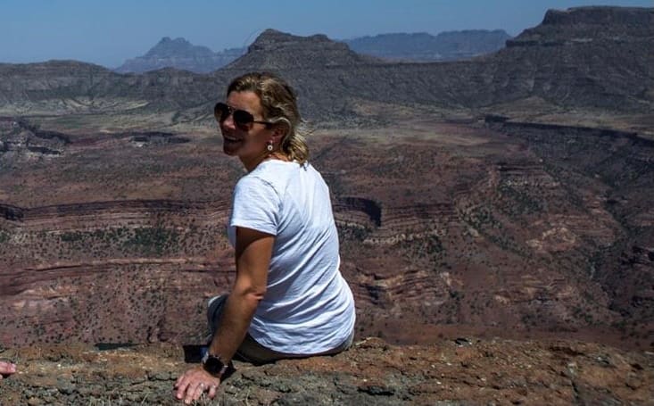New Zealander Flick Taylor sitting on the edge of the Tekeze Gorge in Ethiopia on a helicopter recce safari in October 2019.