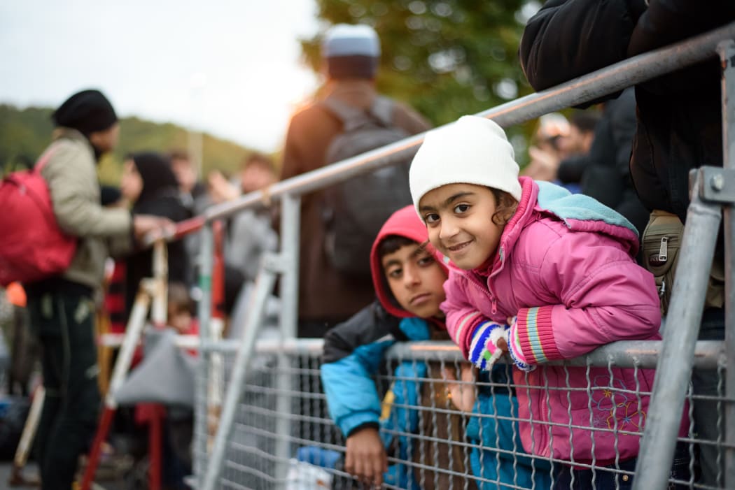 Migrants and refugees wait to cross the Slovenian-Austrian border in Sentilj, Slovenia.
