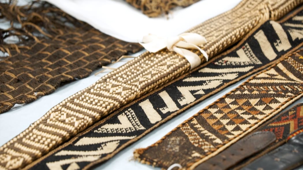 Fine examples of tātua (belt), taniko (finger weaving) and tātua whakairo (patterned belt).