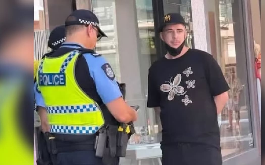 Police speak to Liam Alexander Hall on the day of the Perth Invasion Day Rally.