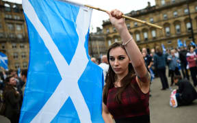 Waveing a Scottish Saltire at a "Yes" campaign rally in Glasgow.