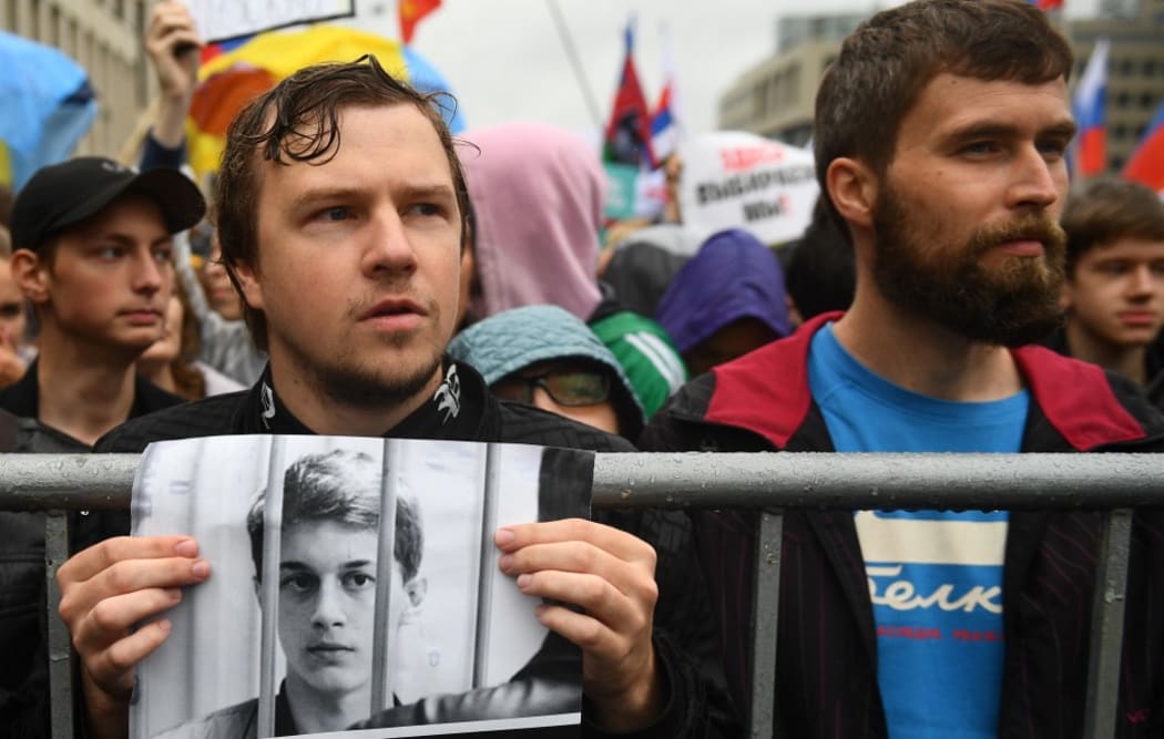 People attend a rally in support of the registration of independent candidates for the September's elections to the Moscow City Duma and against police brutality, in Moscow, Russia.