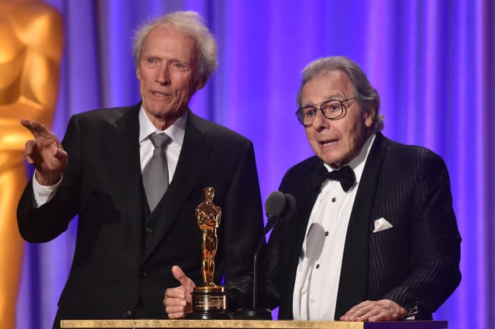US actor Clint Eastwood introduces Argentinian composer Lalo Schifrin (R) accepting an honorary Oscar at the 10th Annual Governors Awards gala hosted by the Academy of Motion Picture Arts and Sciences at the the Dolby Theater at Hollywood & Highland Center in Hollywood, California on November 18, 2018. (Photo by Robyn BECK / AFP)