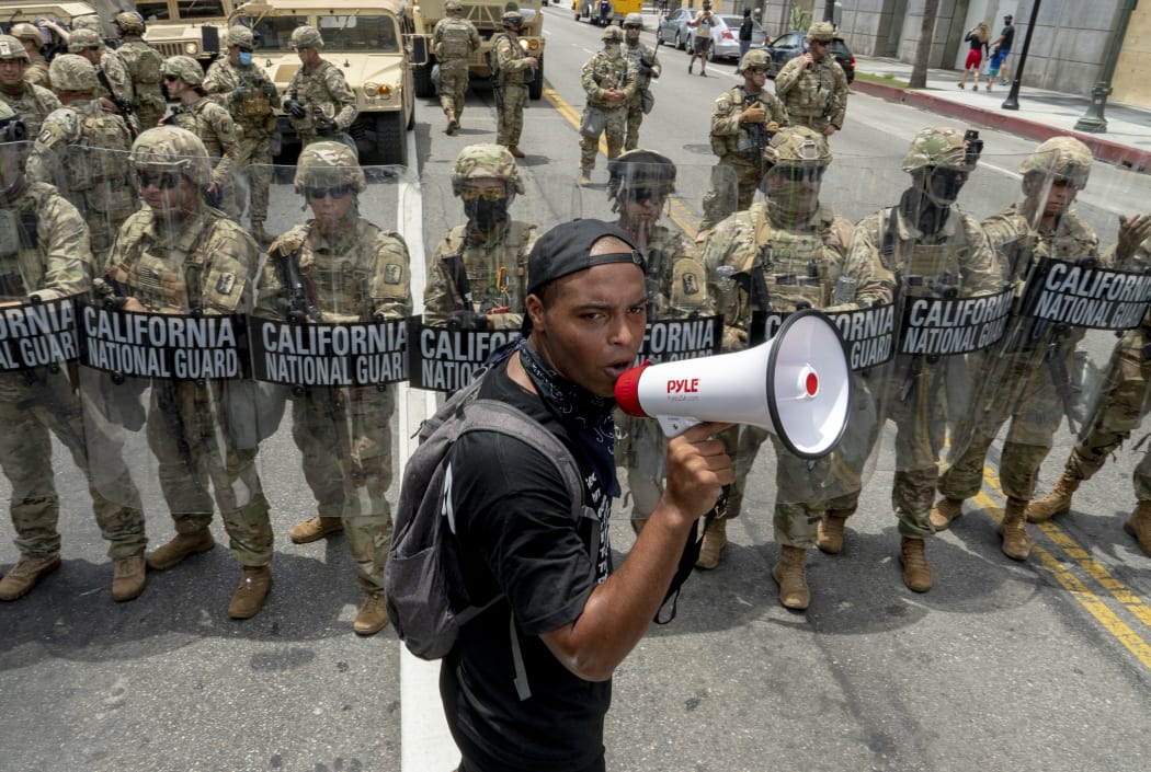 A protester speaks in front of the California National Guard during a demonstration over the death of George Floyd while in Minneapolis Police custody, in Los Angeles, California, June 2, 2020.