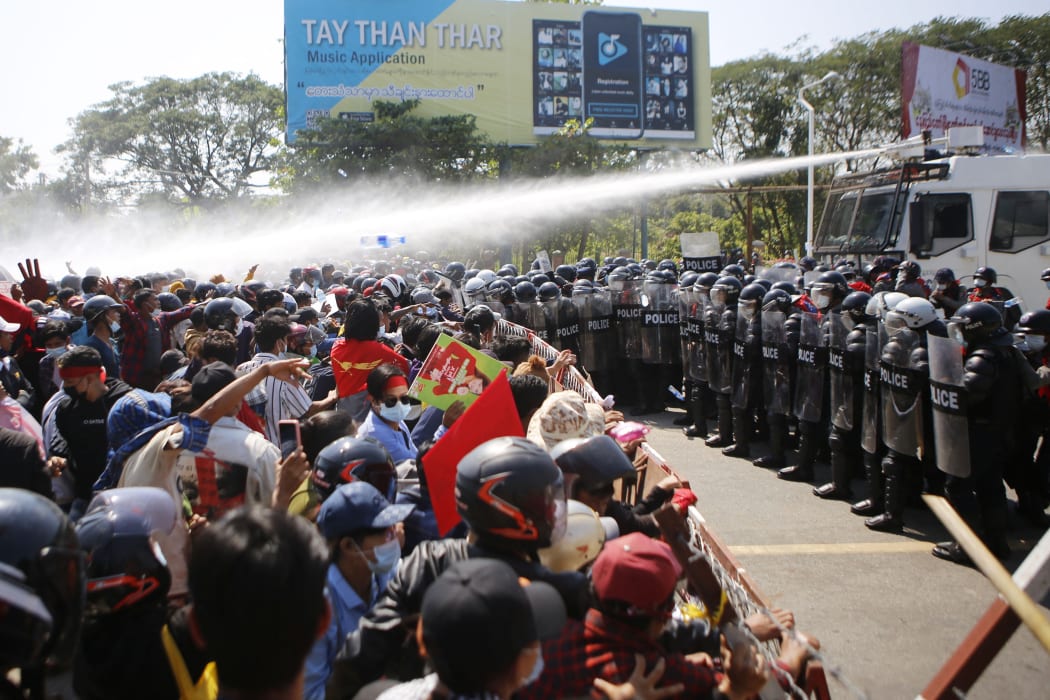 Police fire water cannon at protesters as they demonstrate against the 1 February   military coup in the capital Naypyidaw, 9 February, 2021.