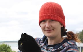 Cat-lover Nico Jarvis, of Omaui, holding her neighbour’s 8-year-old cat, Nhabuz Fishaw.