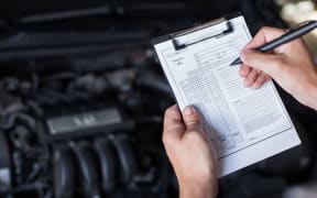 mechanic repairman inspecting car closeup