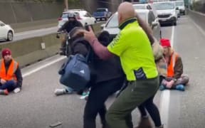 The protesters were met by angry motorists, one of whom grabbed them.
