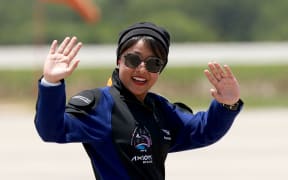 Saudi astronaut Rayyanah Barnawi waves before being brought to the SpaceX Falcon 9 rocket with the Crew Dragon spacecraft for launch from pad 39A at the Kennedy Space Center on May 21, 2023 in Cape Canaveral, Florida. The crew will be flying to the International Space Station to conduct science experiments.
