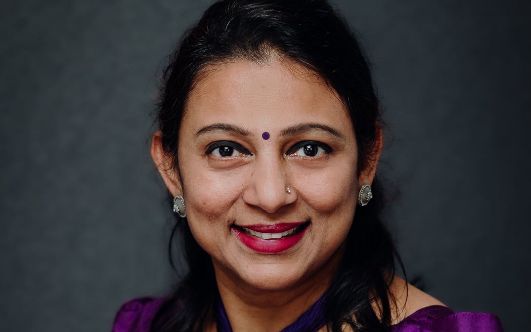 Head shot of middle age Indian woman in traditional garb.