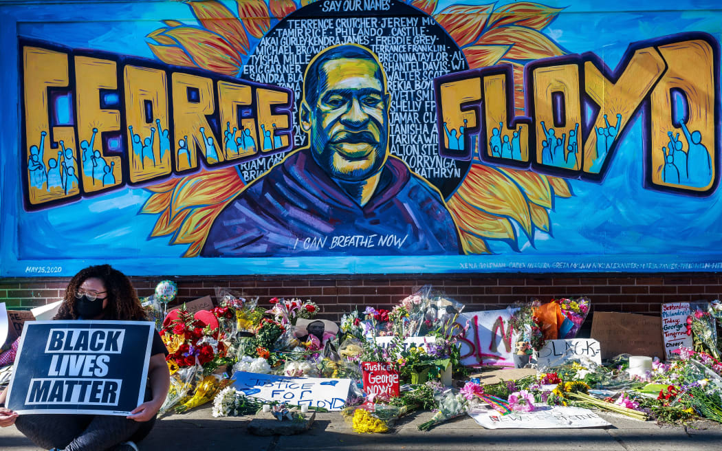 Flowers, signs and balloons are left near a makeshift memorial to George Floyd near the spot where he died while in custody of the Minneapolis police, on May 29, 2020 in Minneapolis, Minnesota.