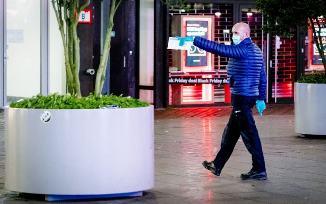 A forensic worker investigates at the Grote Marktstraat, one of the main shopping streets in the centre of the Dutch city of The Hague, after several people were wounded in a stabbing incident on November 29, 2019.