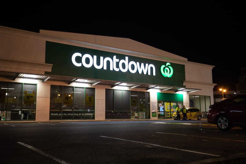 Police standing guard outside the Cumberland Street Countdown in Dunedin on Tuesday night after four people were stabbed there in an attack that afternoon.