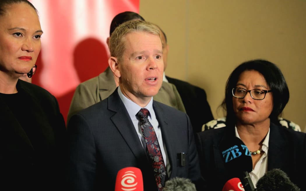 Opposition leader Chris Hipkins speaks to media after making his State of the Nation speech on 7 March, 2025, flanked by Carmel Sepuloni (left) and Barbara Edmonds.